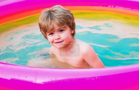 Photo for Kids beach fun. Kids learn to swim. Child swimming pool. Happy little boy playing in swimming pool outdoor on hot summer day. Healthy outdoor sport activity for children - Royalty Free Image