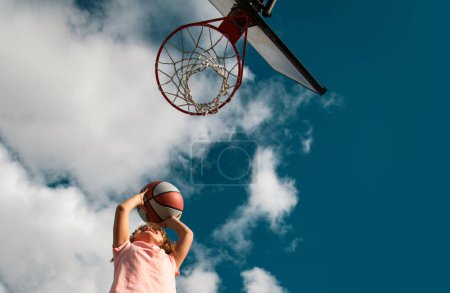 Photo for Kid boy concentrated on playing basket ball - Royalty Free Image