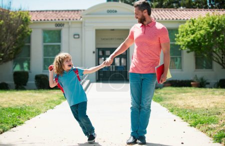 Foto de Father and son run with father after come back from school. Family education and school outdoor concept - Imagen libre de derechos