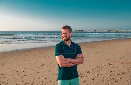 Photo for Portrait of man on beach. Outdoor portrait of handsome man posing at beach, in nice sunny day, wearing casual sorts classic t-shirt - Royalty Free Image