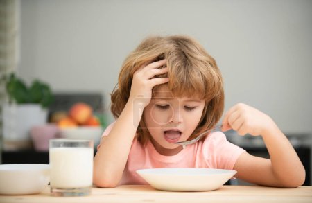 Photo for Funny kid with plate of soup. Child dinner - Royalty Free Image