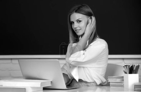 Photo for Focused student, young woman online watching webinar on laptop, listening learning education course. Portrait of cheerful university student looking at camera - Royalty Free Image