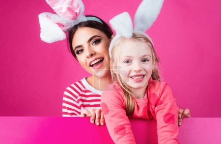 Photo for Two sisters hunting for Easter eggs. Girls with bunny ears. Spring holidays - Royalty Free Image