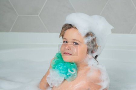 Photo for Child bathes in a bath with foam. Bath tub with soap bubble - Royalty Free Image