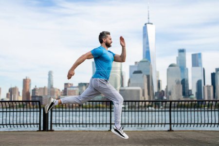 Photo for Hispanic Man runner in sport outfit run in NYC. Motion, healthy run. Jogger run near Manhattan downtown. Muscular athlete sportsman run in city. Running sportswear. Handsome guy running workout - Royalty Free Image