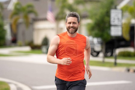 Photo for Middle aged millennial hispanic man 40s jogging outside in morning, senior sportsman enjoying active healthy lifestyle. Male athlete sports model fit and healthy life - Royalty Free Image