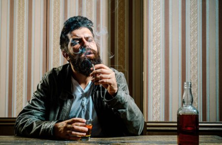 Photo for Handsome stylish bearded man is drinking at home after work. Drunk man. Stylish man. Stop drinking. No alkohol. Smoking man - Royalty Free Image