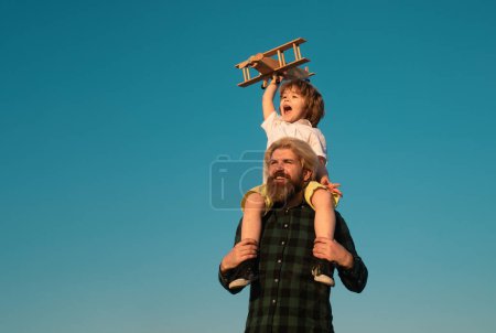 Photo for Father and son playing with wooden airplane. Sweet childhood - Royalty Free Image