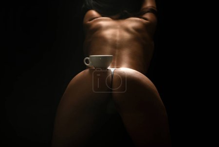 Téléchargez les photos : Coffee espresso energy. Sexy buttocks with coffee cup, perfect butt with coffee. Coffe cup on womans sexy butt. Sexy woman - en image libre de droit