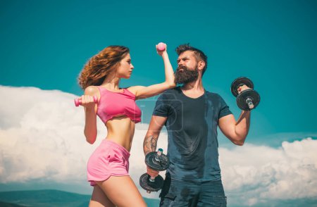 Photo for Athletic people. Young sporty sexy couple showing muscle and workout outside - Royalty Free Image