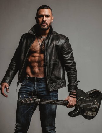Photo for Rock this party. Muscular athletic sexy male with guitar. Confident and handsome brutal man play music. Party for adults. Music dance party. Move your body. Enjoy perfect sound. Rock musician concept. - Royalty Free Image