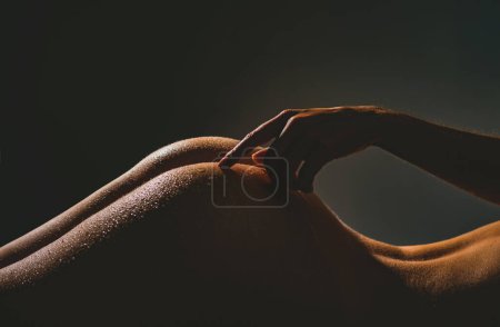 Photo for Sexy point on woman sensual body. Intime love touch G spot. Exstasy and pleasure concept. Tenderness partner. Sensual touch in love. Care and sensual love concept. Hands on beautiful female ass - Royalty Free Image