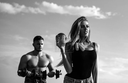 Photo for Slim fitness coach female with protein shaker. Smiling young woman and personal couple coach. Man and girl with protein shake bottle and skipping rope - Royalty Free Image