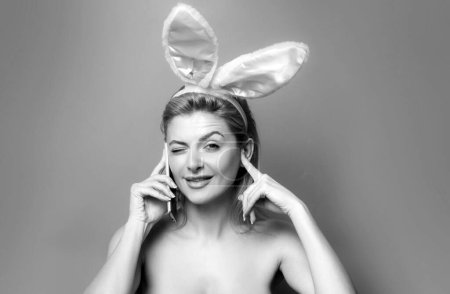 Photo for Happy Easter. Funny young woman talking on the phone, beautiful bunny girl having pleasant funny conversation speaking by mobile, isolated on pink - Royalty Free Image