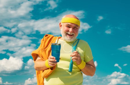 Photo for Senior sport man is doing sport outdoors. Active sport workout for old person. Elderly man practicing sports on blue sky background - Royalty Free Image