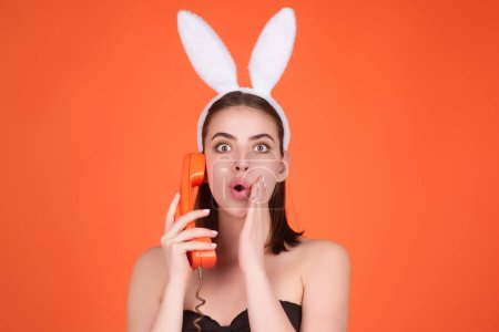 Foto de Close up photo of pretty girl wear easter fluffy bunny ears hold easter eggs, isolated studio background. Eater portrait of female bunny - Imagen libre de derechos