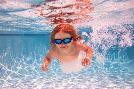 Photo for Child in swimming pool underwater. Kid underwater swim. Child splashing underwater in swimming pool. Active kids healthy lifestyle, swim underwater. Summer vacation with child. Child water game - Royalty Free Image
