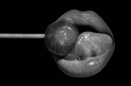 Photo for Sexy blow jobs symbol. Licking candy. Lollipop model. Woman lips sucking a candy. Glamor sexy model with red lips eat sweats lolly pop. Night club background - Royalty Free Image