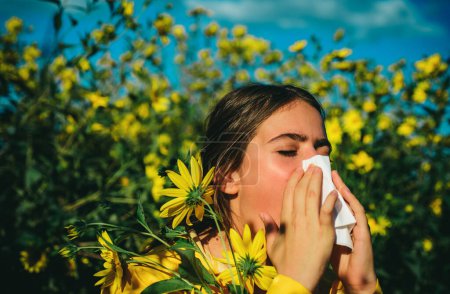 Photo for Allergy medical seasonal flowers concept. Woman with napkin fighting blossom allergie outdoor. Allergy to flowering. Young woman is going to sneeze. Sneezing and runny nose from pollen - Royalty Free Image