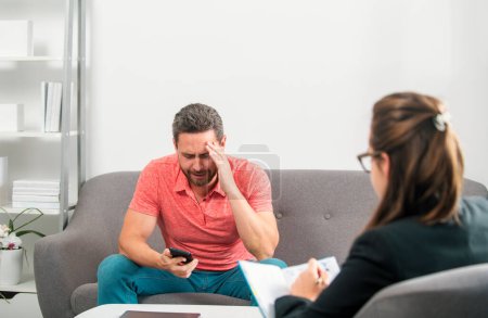 Photo for Man discussing his psychological problems with a psychiatrist during a therapy session. Social worker counseling parental - Royalty Free Image