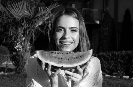 Photo for Portrait of a happy young woman with watermelon. Youth lifestyle. Happiness summer holiday. Positive charming youth girl about biting wedge of juicy watermelon enjoying summer - Royalty Free Image