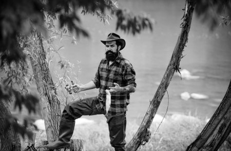 Téléchargez les photos : Fishing hobby and summer weekend. Portrait of bearded men fisher with fishing rod and net. Angler - en image libre de droit