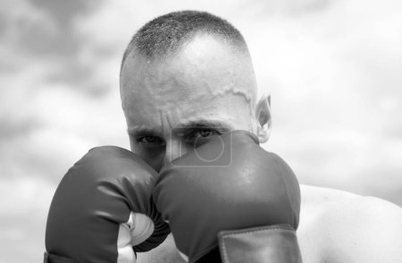 Photo for Closeup portrait of boxer practicing punches in boxing. Boxer punching in boxing gloves. Sporty man during boxing exercise. Strength and motivation - Royalty Free Image