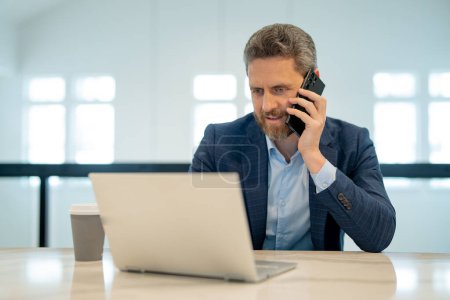 Photo for Business office interior. Businessman chatting phone online in office. Business man in suit using phone. Office worker solves cases on phone. Office manager talk phone. Ceo manager using smartphone - Royalty Free Image