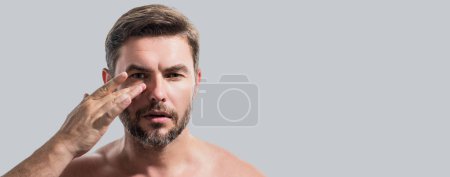 Close up portrait of man 40s having bristle isolated over gray background. Handsome man enjoy fresh perfect smooth skin. Beautiful man with perfect faces skin. Banner for header, copy space