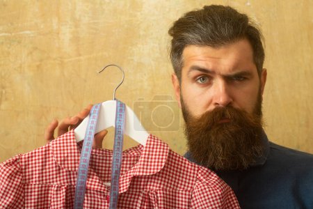 Photo for Man seamstress dressmaking. Close up portrait of old fashion seamstress tailor sewing. Dressmaker seamstress man sews clothes for woman. Sewing. Man seamstress sews female clothes. Sewing process - Royalty Free Image