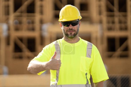 Photo for Worker man on the building construction. Construction site worker in helmet work outdoors. Builder worker working on construction site. Construction site worker outdoor portrait - Royalty Free Image