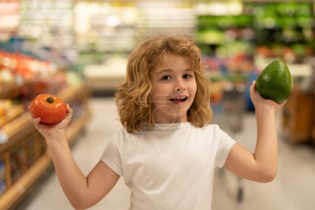 Photo for Child in food shop in food market store. Kids shopping in food shop supermarket. Sales, shop and shopping. Kid in shop. Shopping market. Shopping center. Child buy food in supermarket - Royalty Free Image