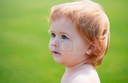 Photo for Cute little baby on the meadow field. Toddler child walking outdoor, family vacations, summer season nature. Baby face close up. Funny little child closeup portrait. Blonde kid, emotion face - Royalty Free Image