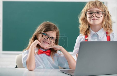 Photo for School friends learning together. Friendly classmates in school uniform at lesson. Boy and girl children at school. Schoolkids and friendship, school friends. Classmates couple, primary students - Royalty Free Image