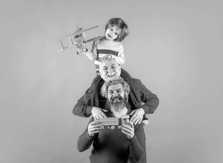 Photo for Grandfather father and grandson playing with toy plane. Boy dreams of becoming a pilot. Journey travel trip concept. Isolated - Royalty Free Image