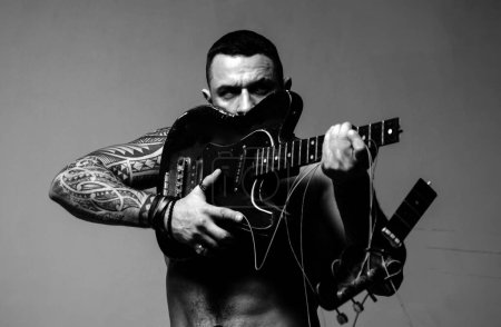 Foto de Emocionado hombre sexy con guitarra eléctrica. Música, performance, entretenimiento - Imagen libre de derechos