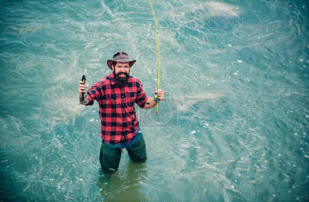 Photo for Fisherman caught a fish. Man fishing on river. Excited amazed fisher man in water catching trout fish, top view - Royalty Free Image