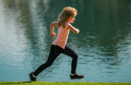 Photo for Kids jogging in park outdoor. Little boy running in nature. Active healthy child boy runner jogging outdoor. Jogging helps the body to be strong - Royalty Free Image