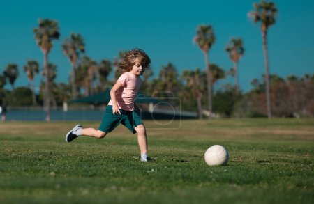 Photo for Soccer kid. Kids play football on outdoor stadium field. Little boy kicking ball. School football sports club. Training for sport children. Kids play soccer game - Royalty Free Image