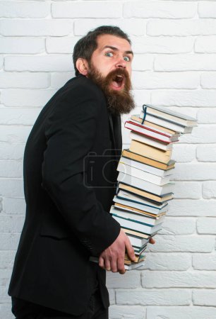 Photo for Portrait of a funny teacher or professor with book stack. Books stacked fall. Falling books concept. Mature professor, middle aged teacher, bearded fun man. Study concept - Royalty Free Image