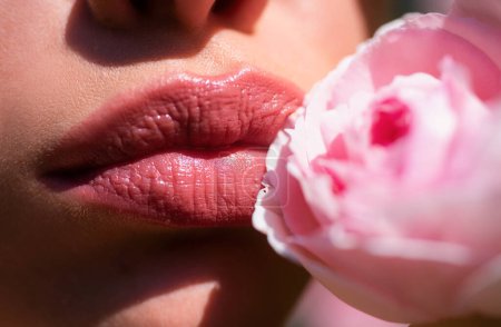 Téléchargez les photos : Lips with lipstick closeup. Beautiful woman lips with rose. Close up, macro with beautiful mouths - en image libre de droit