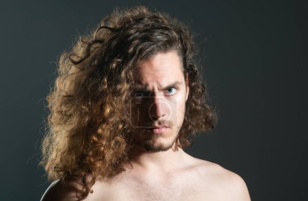 Photo for Man with curly hair. Close up portrait of attractive modern handsome muscular brunette man with perfect curly hair isolated on gray background copy space - Royalty Free Image