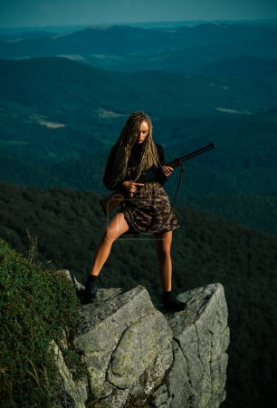 Photo for Hunting - women hobby. Hunting Gear and Hunting Clothing Equipment for hunter. Woman hunter with a gun - Royalty Free Image