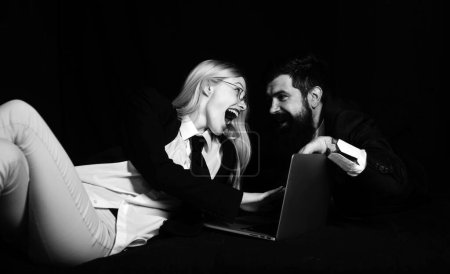 Photo for Excited business couple of stylish hipster guys and businesswoman discuss about new company project, using computer - Royalty Free Image