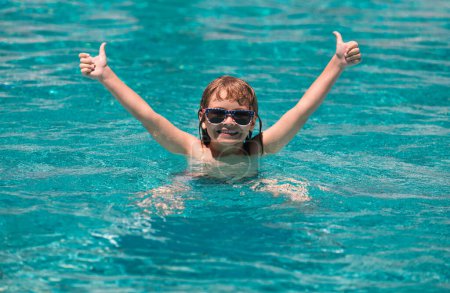 Photo for Child raised hands relax in summer swimming pool - Royalty Free Image