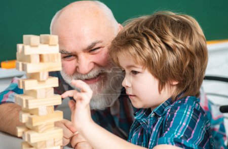 Téléchargez les photos : Close up portrait of grandfather and grandson child playing at home - en image libre de droit