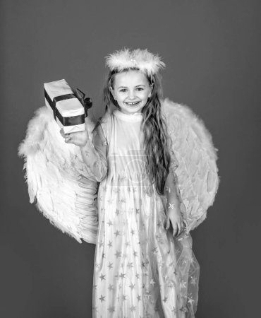 Photo for Cute angel happy smiling child girl with angels wings, isolated on red. Valentines day - Royalty Free Image