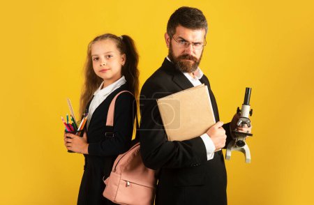 Photo for Portrait of schoolgirl in school uniform and serious teacher in studio. Portrait of amazed excited happy pupil school girl and tutor, isolated - Royalty Free Image