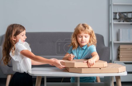 Photo for Kids open pizza box at home. Children preparing to eat pizza - Royalty Free Image