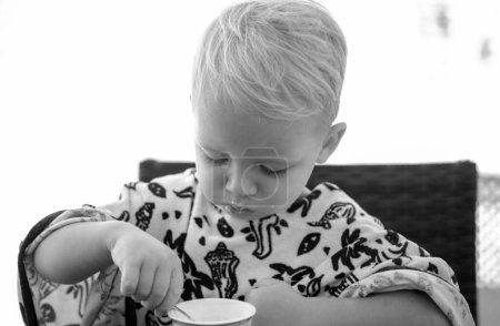 Photo for Baby food, babies eating. Little boy eating yogurt - Royalty Free Image